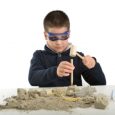 Child using tools at an archeology dig site