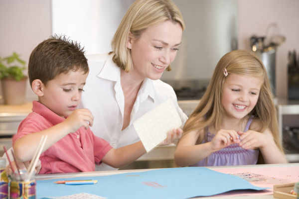 Woman doing art with children at home