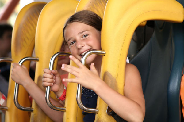 Cute girl ready to ride on a roller coaster