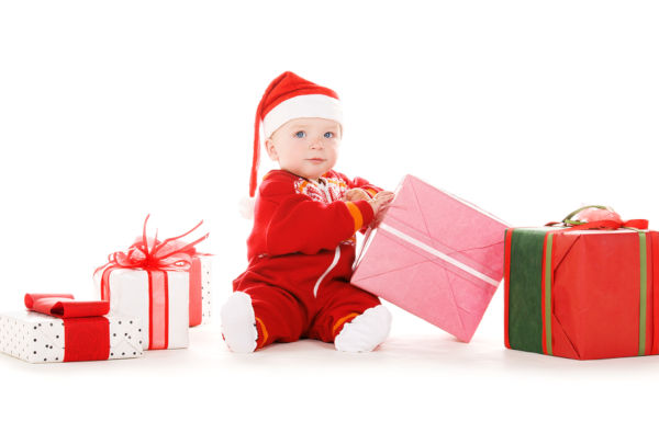 santa helper baby with christmas gifts over white