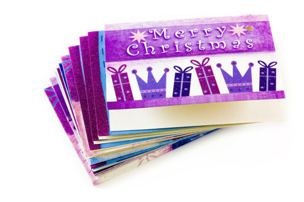 Christmas tags in a pile on white background