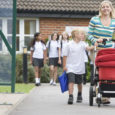 Woman Leaving School With Child And Push Chair