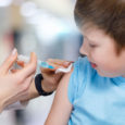 A Closeup Of A Teenage Child Receiving A Vaccine From A Pediatri
