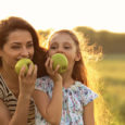 Happy Mum and daughter eating