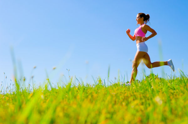 Athletic woman working out in a meadow