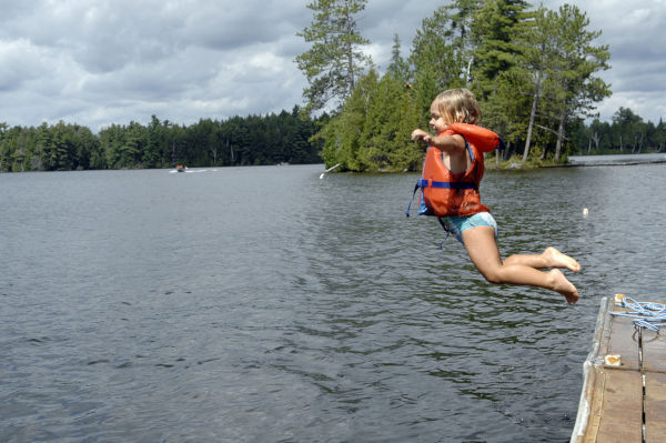 Little Girl Jumping Into Lake