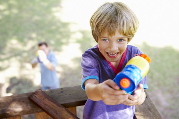 Boy using a water pistol