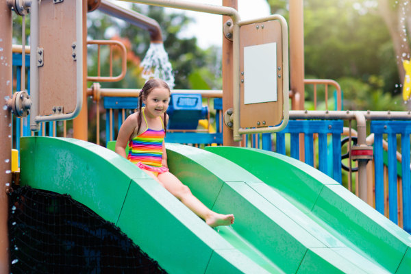 Child going down a slide at a waterpark