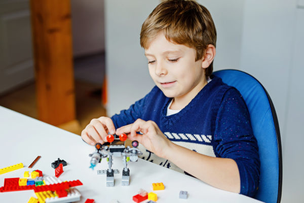 Child playing with Lego.