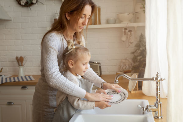 Child helping Mum to wash up