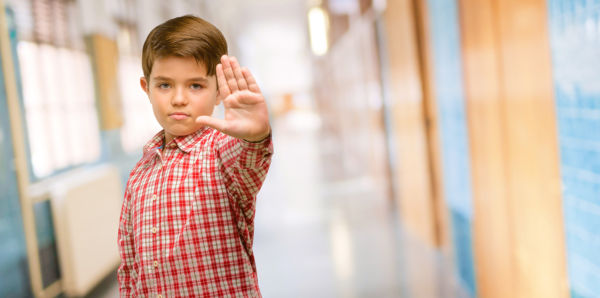 Child using hand to tell someone to stop