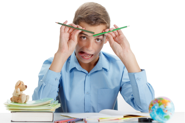 Funny child is naughty reading a book at School.