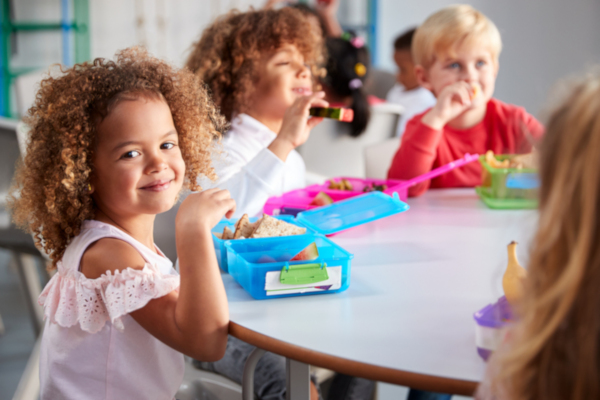 Children eating packed lunches at school