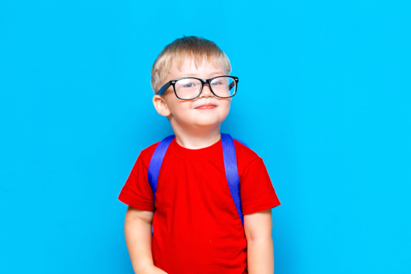 Happy Smiling Boy In Red T-shirt In Glasses Is Going To School 