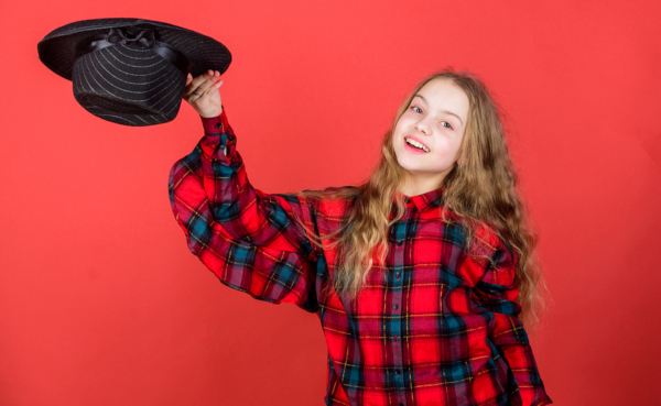 Girl performing with a hat, practicing acting