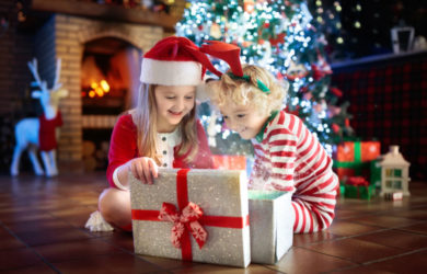 Child At Christmas Tree. Kids At Fireplace On Xmas