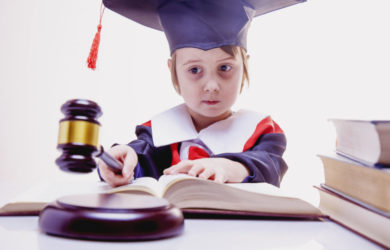 Portrait of serious child girl judge makes a decision.