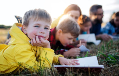 Group of school children with teacher on field trip in nature.