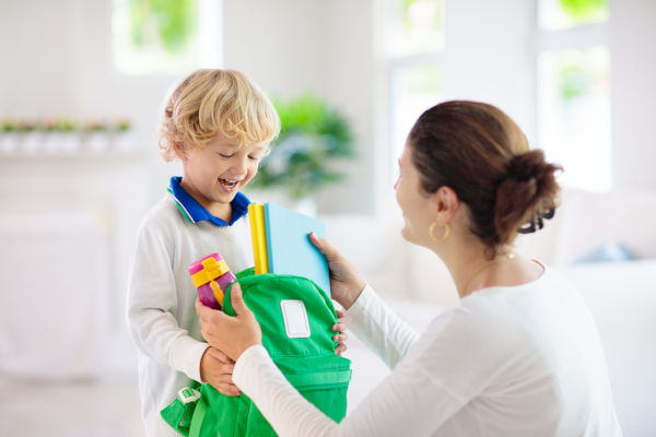 Mother checking child's rucksack for school