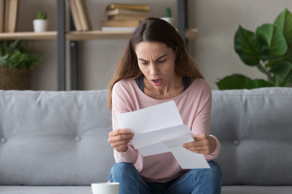 Shocked woman reading a letter