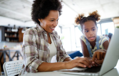 Mother and daughter working on a laptop