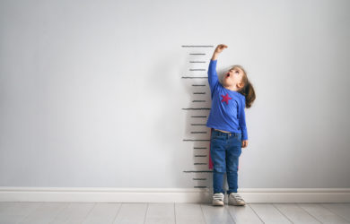 Child measuring how much they have grown