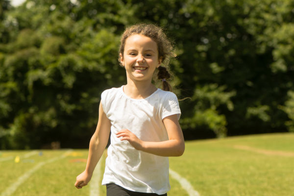 Young girl running at school