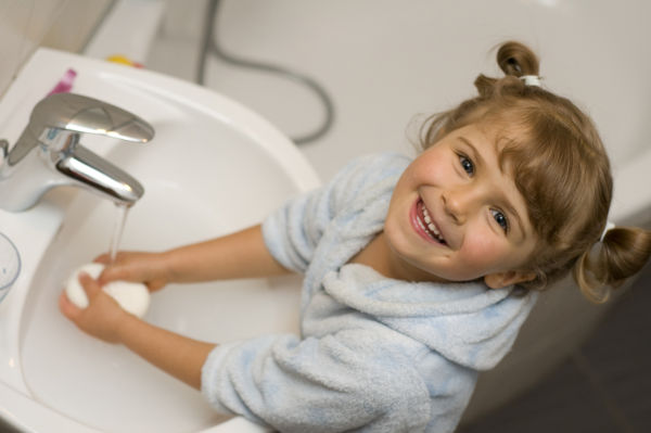 Little girl washing her hands