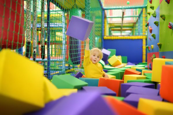 Young boy playing in soft play centre
