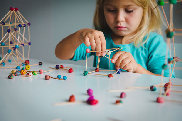 child making geometric shapes, engineering and STEM