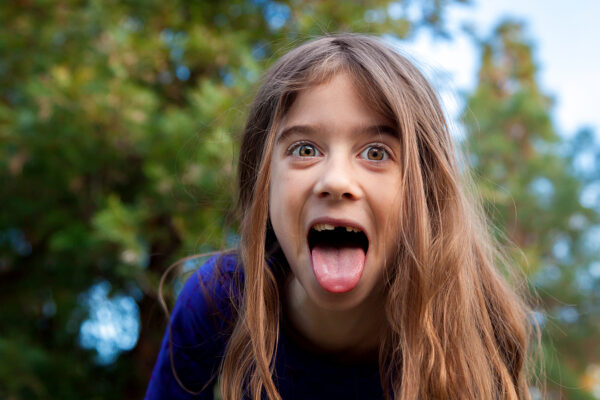 A young girl makes a funny face for the camera. 