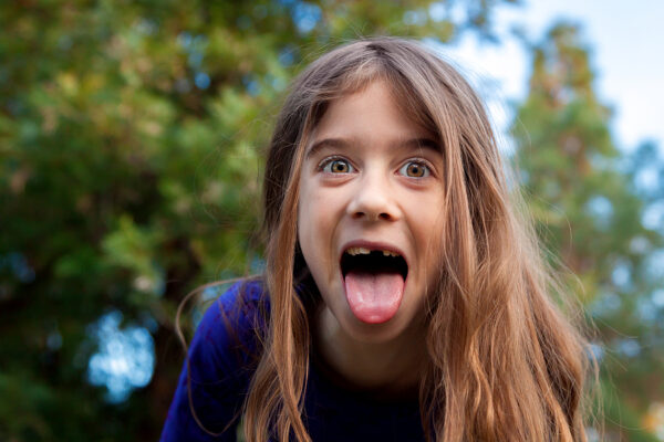 A young girl makes a funny face for the camera. 