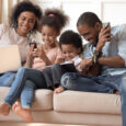 Happy family playing on different devices