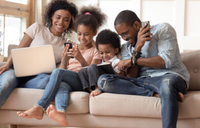 Happy family playing on different devices