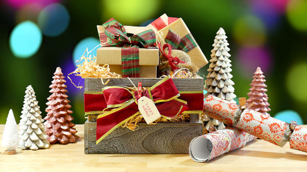 Large English style traditional Christmas hamper with wrapped gifts and food.